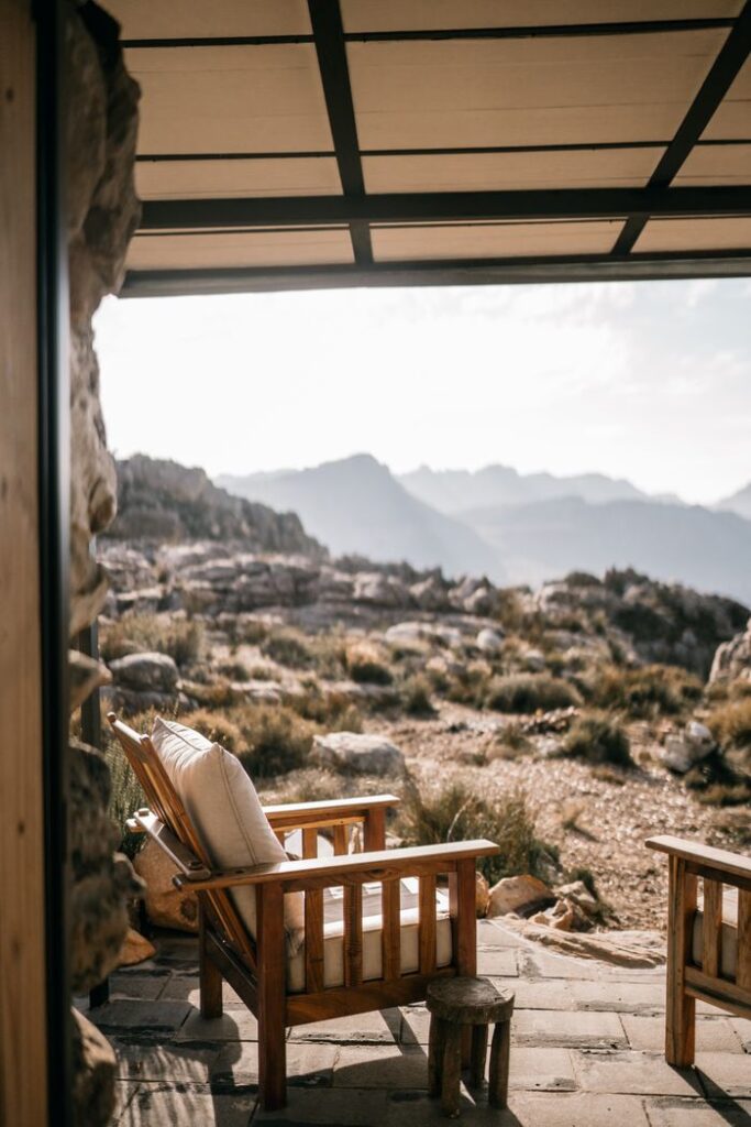 Crafting Captivating Headlines: Your awesome post title goes here Tranquil outdoor seating area with armchairs overlooking a mountainous landscape.